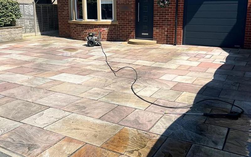 Stone driveway part way through a pressure wash